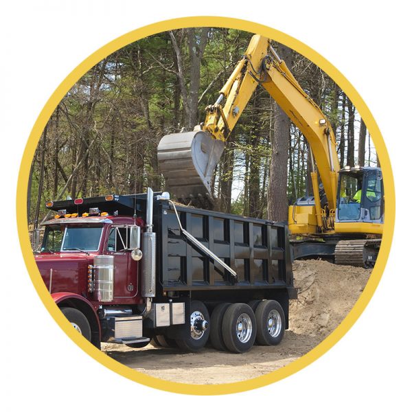 Construction trucks clearing land