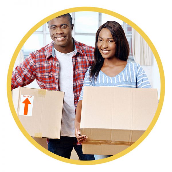 Young couple smiling with moving boxes