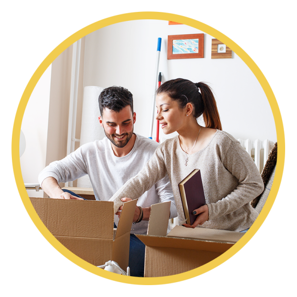 Young couple unpacking boxes in their new home