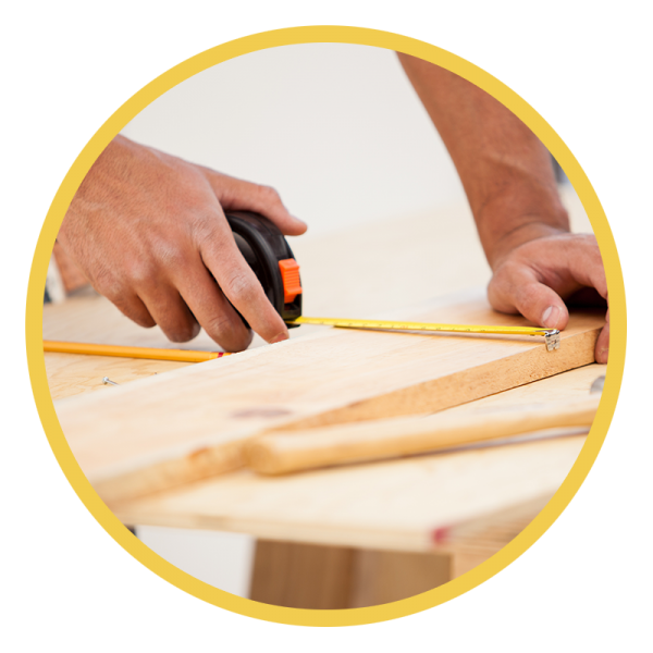 Man measuring a piece of wood to cut