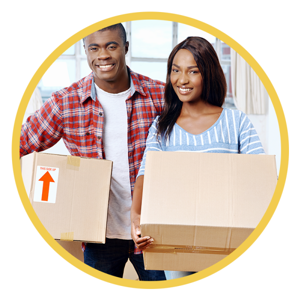 Young couple smiling with moving boxes