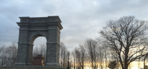 Tilton Arc surrounded by trees with sunset