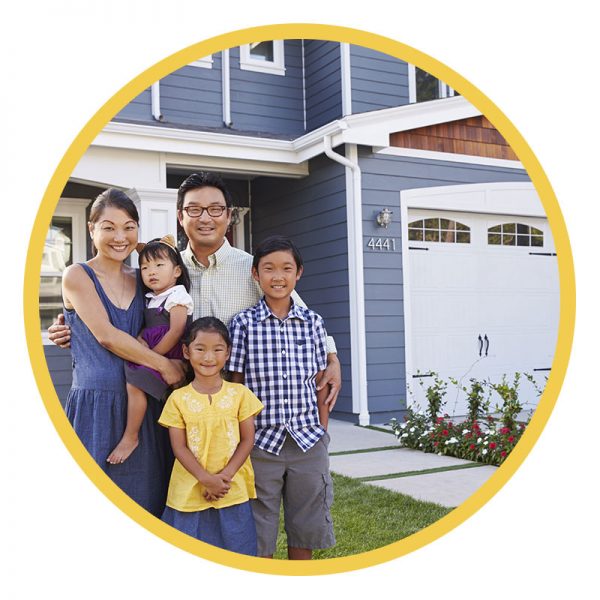 Family standing in front of new home