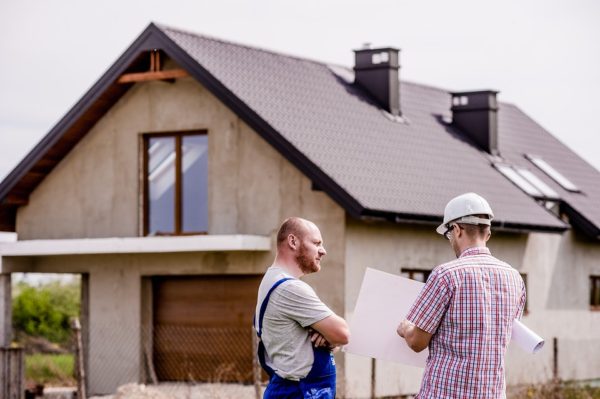 Contractors standing outside of a house