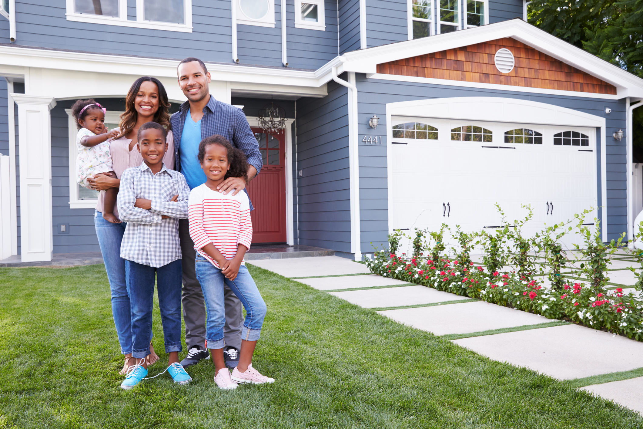 Family standing in front of new home