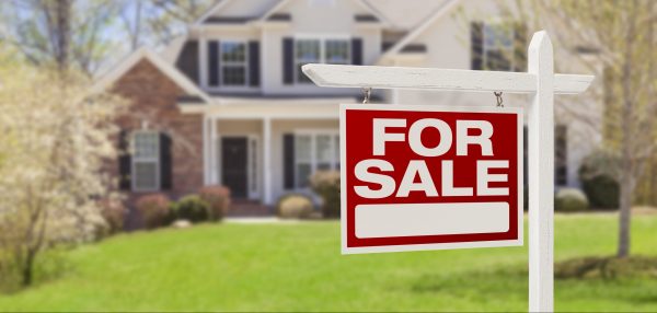 Picture of a fore sale sign in front of a house
