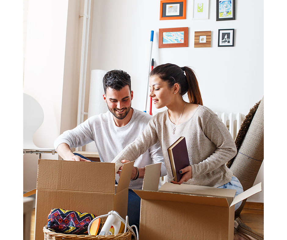 Husband and wife unpacking boxes