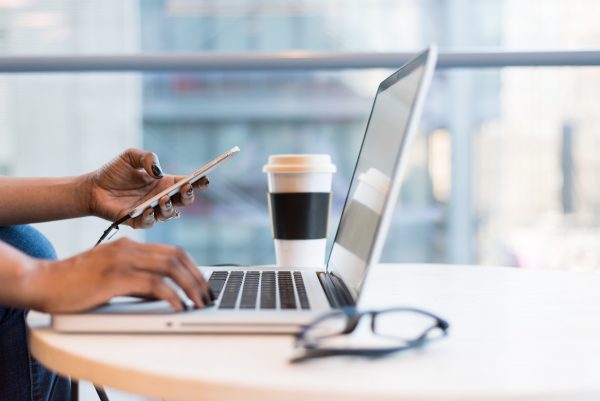 Woman on laptop and cell phone