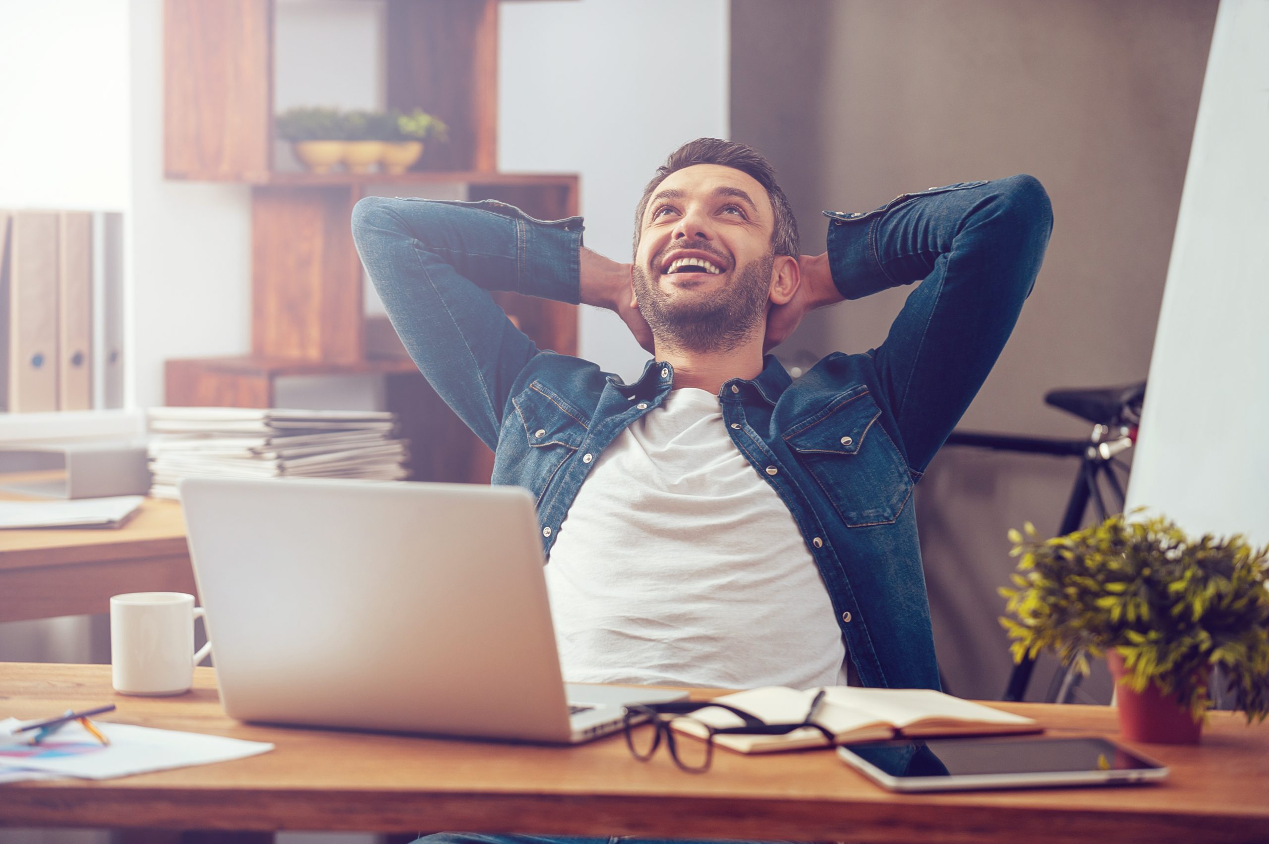 Man sitting at laptop looking relaxed.