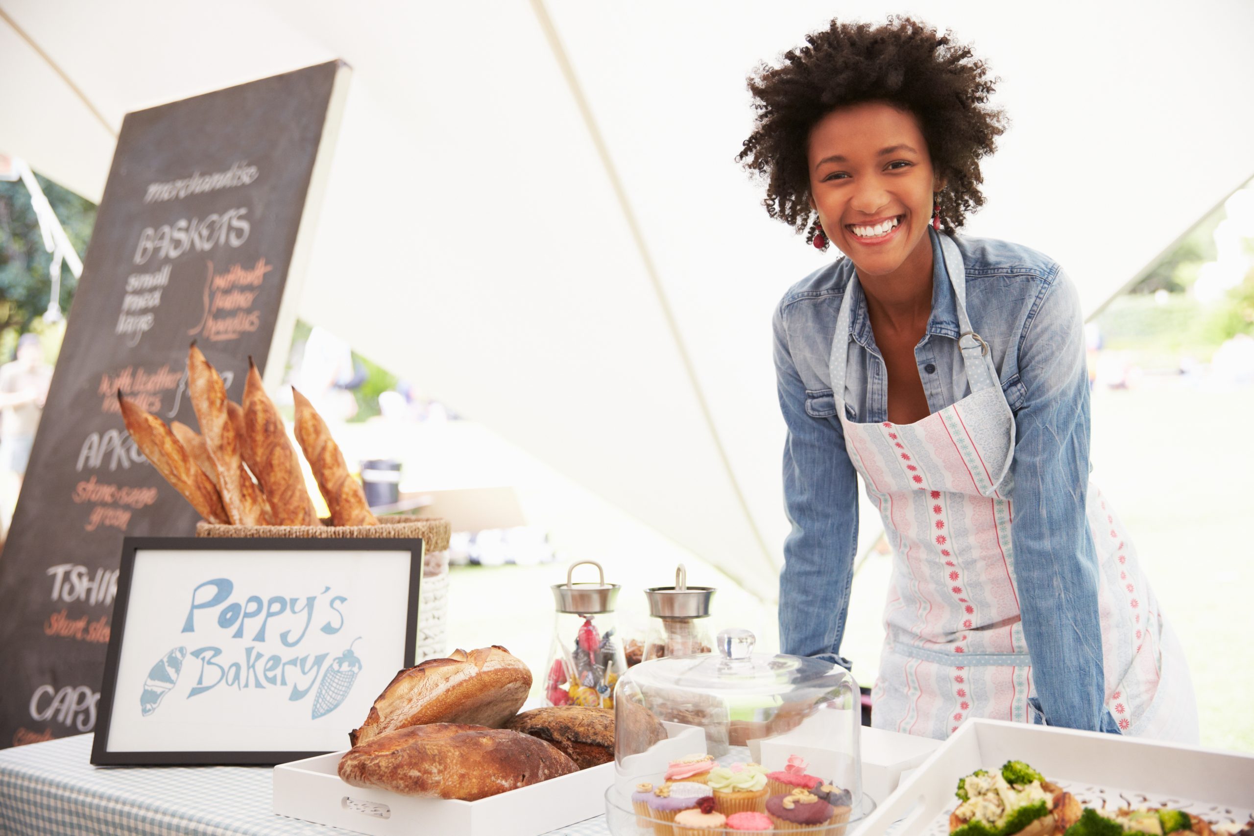 African American bakery owner standing at bakery counter