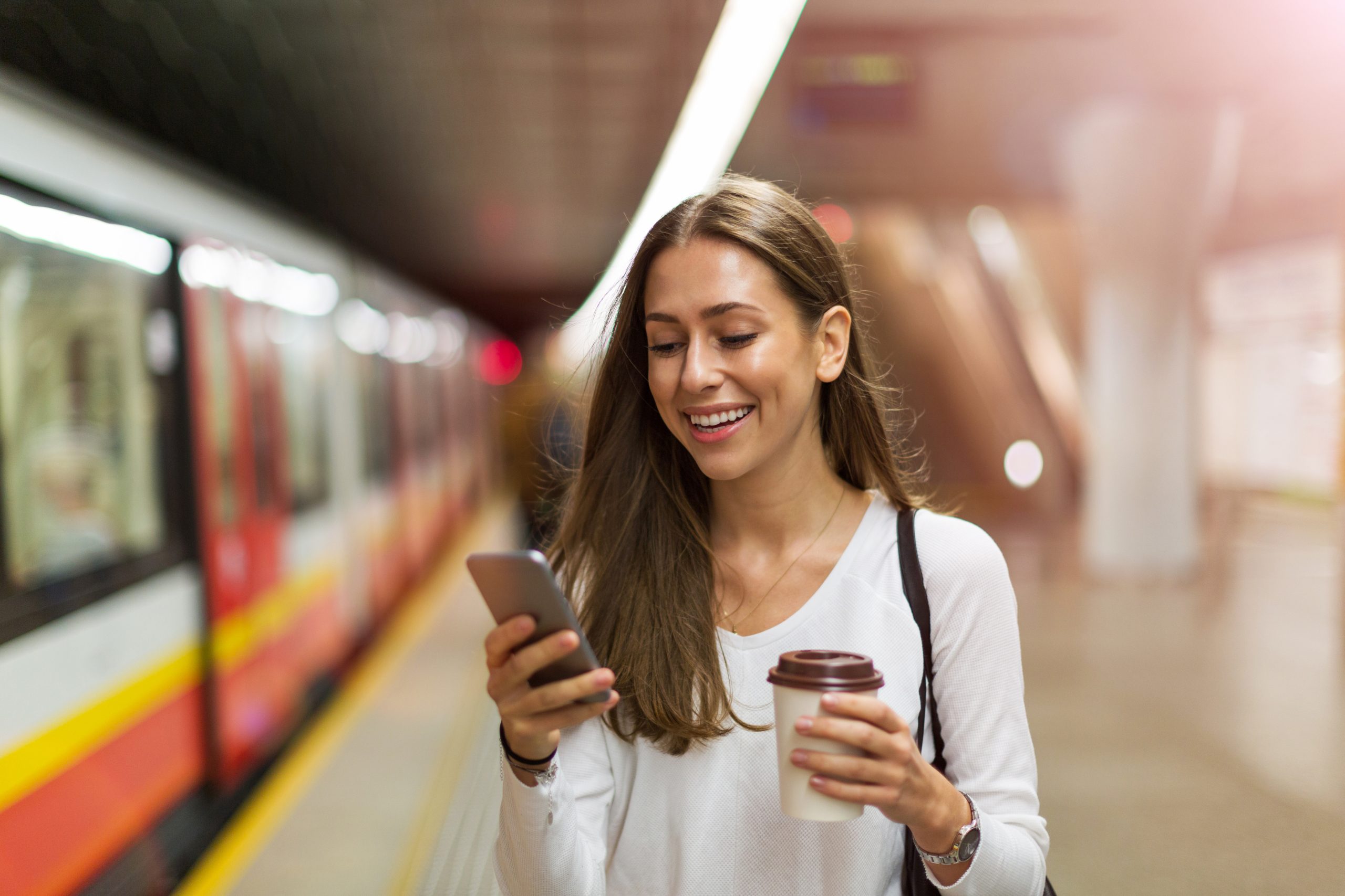Woman in subway looking at cell phone