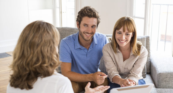 Image of a young couple meeting with a banker.