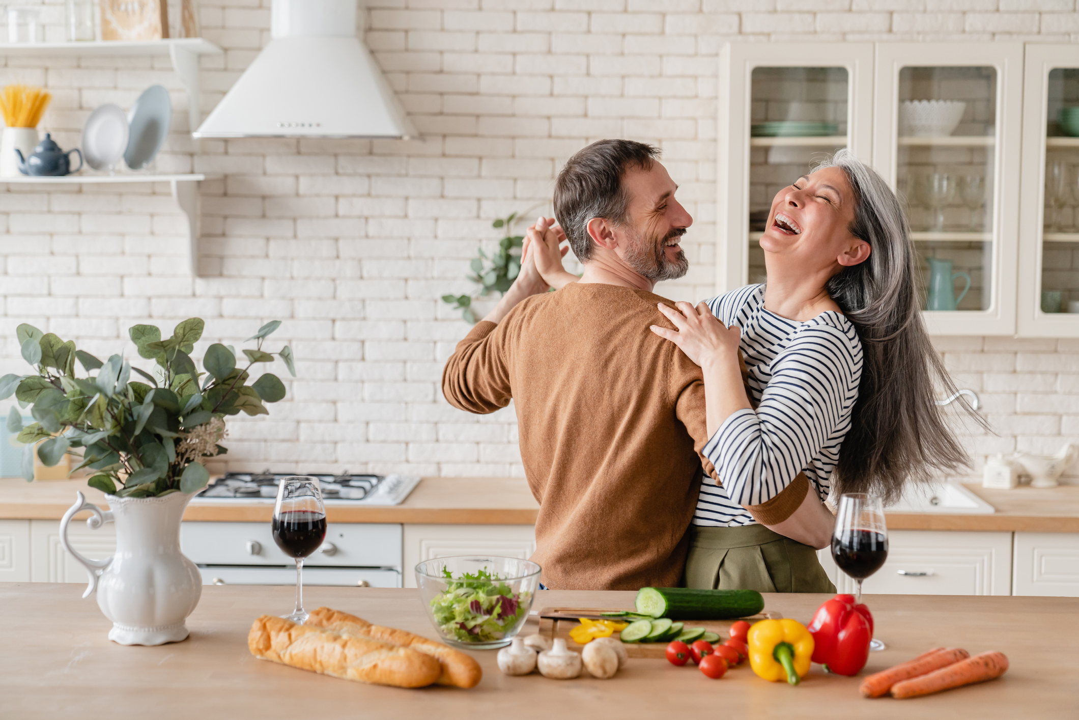 Photo of older couple dancing in kitchen