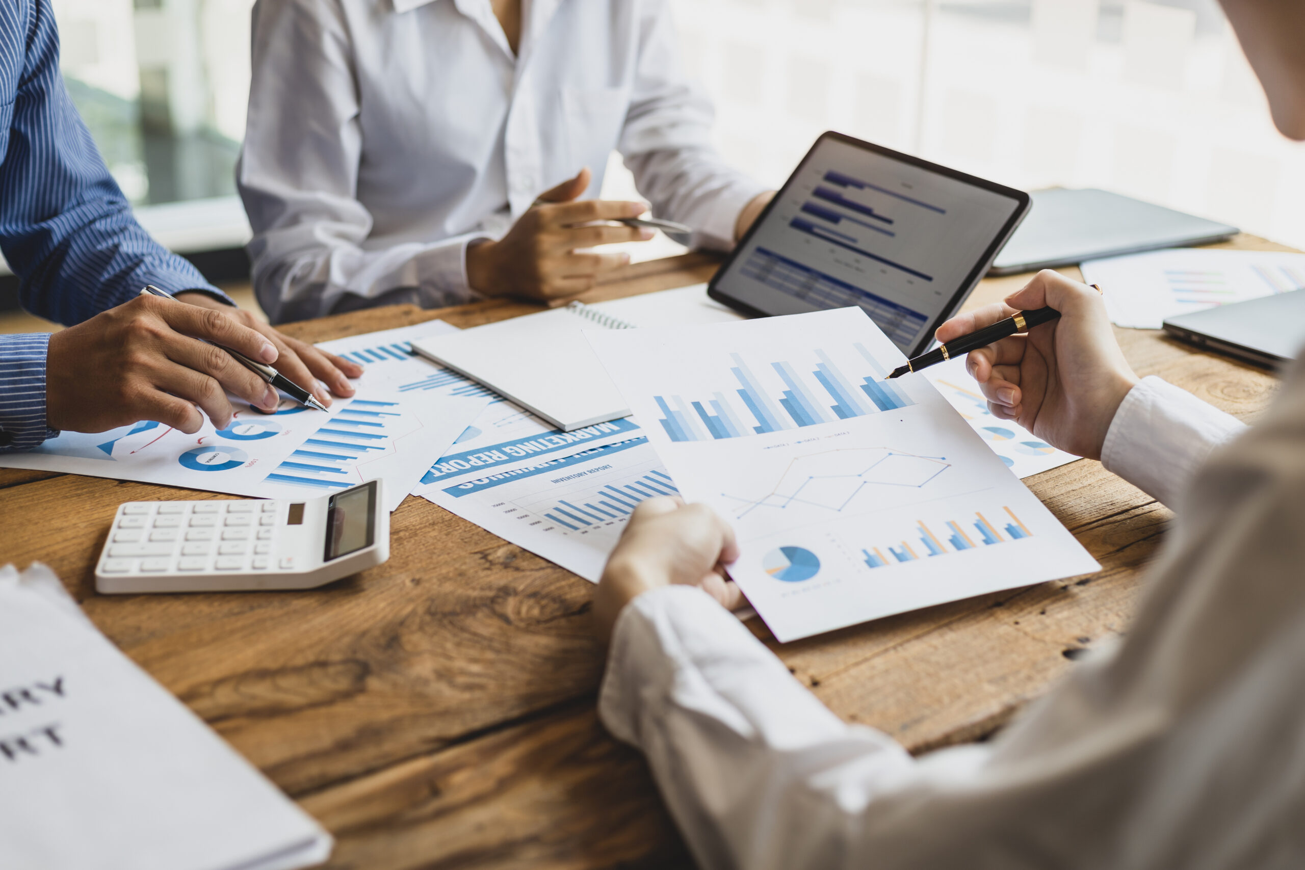 Image of a couple sitting around a table looking at charts and graphs