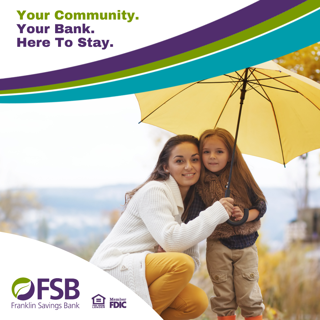 Mother and daughter under a yellow umbrella in the fall rain