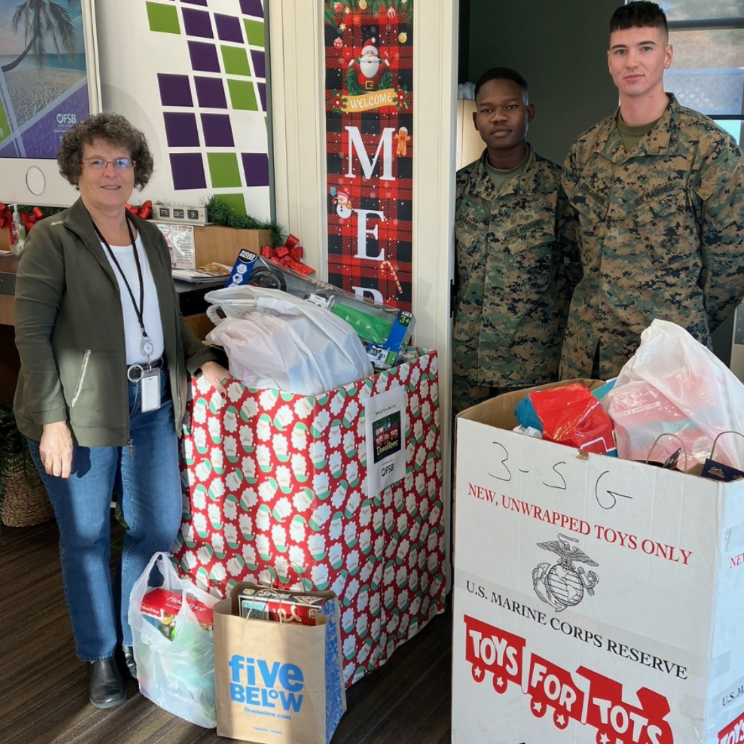 Our Merrimack Team standing with the Marines for their Toys for Tots Drive