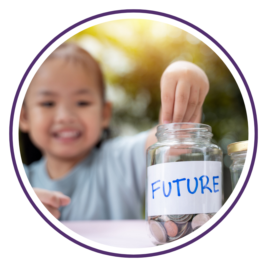Young Asian girl putting money into her future finances jar