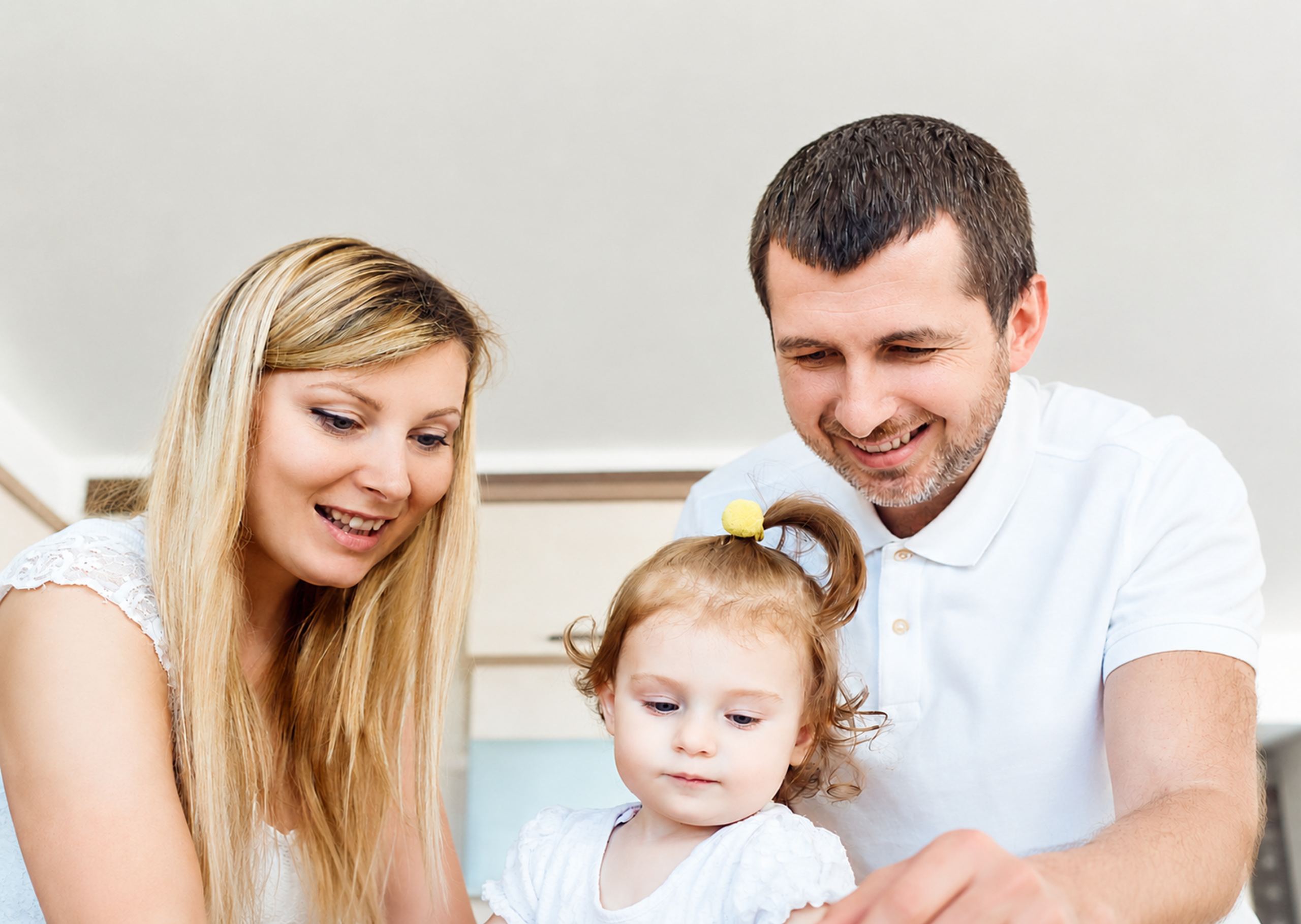 a couple smiling with their baby